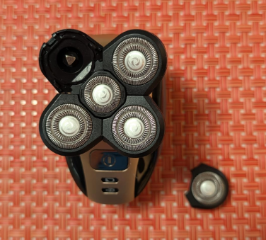 Roundry with open head and a spare blade part on a patterned surface