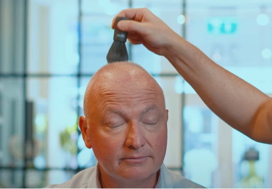 A person applying care product after using a Roundry, demonstrating how it supports both shaving and care, turning bald styling into a confident, modern lifestyle choice.